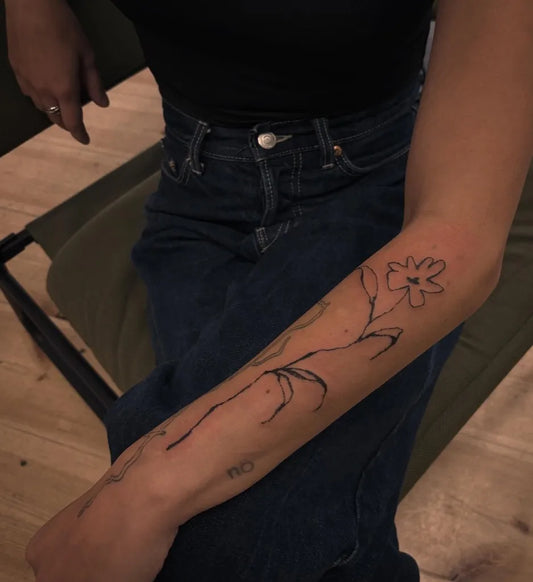 Small Linework Chamomile on Women Arm Flower Tattoo by @tattoo_dami