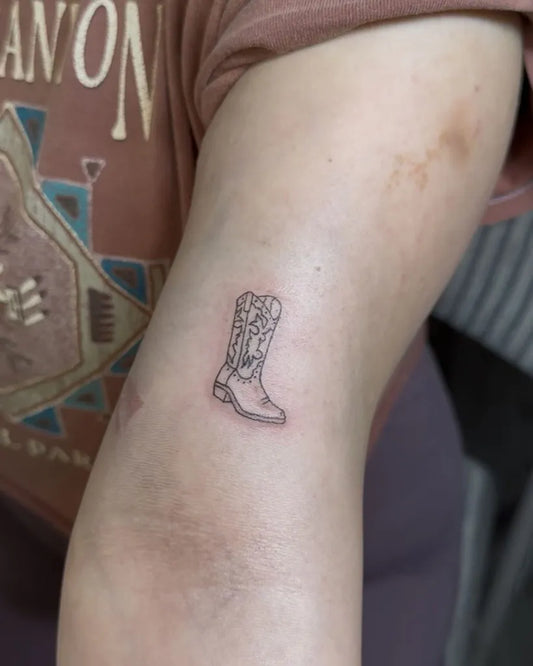 Small Linework Cowboy Boot on Women Arm Tattoo by @violett.inkk