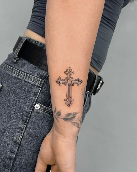 Small Linework Cross and Leaves on Women Wrist Tattoo by @inked.bystephh
