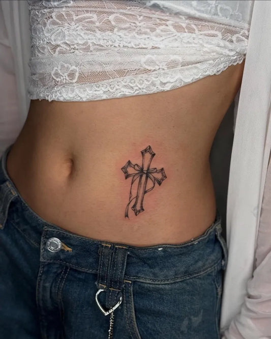 Small Linework Cross on Women Stomach Tattoo by @sea_of_ink_tattoo_studio