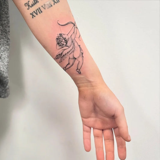 Small Linework Cupid with Arrow on Women Forearm Tattoo by @elizabethftattoos
