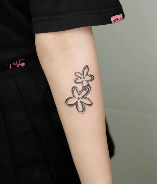 Small Linework Daisy Tattoo on Women Arm by @lonewolf_studio