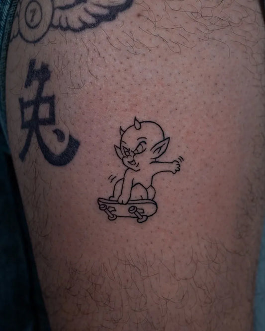 Small Linework Demon on Skateboard Tattoo on Men Arm by @ggdollzz