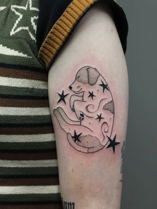 Small Linework Dog with Stars Tattoo on Women Arm by @amandaktattoos
