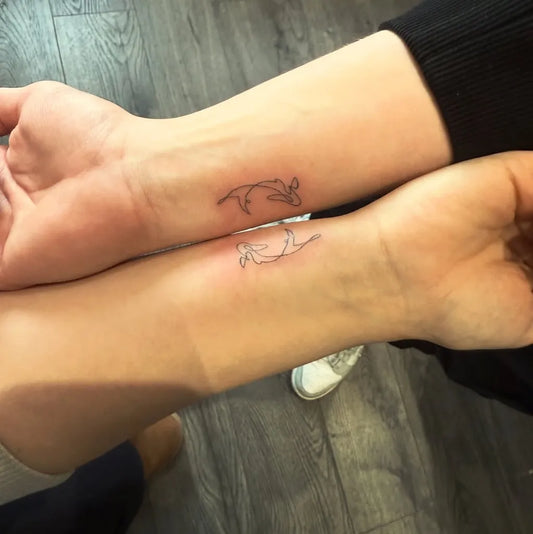 Small Linework Dolphins on Couple Wrists Matching Tattoo by @dinkytattoocardiff