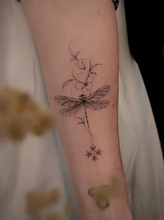 Small Linework Dragonfly Flowers Snowflakes on Women Arm Tattoo by @zoe.fineline