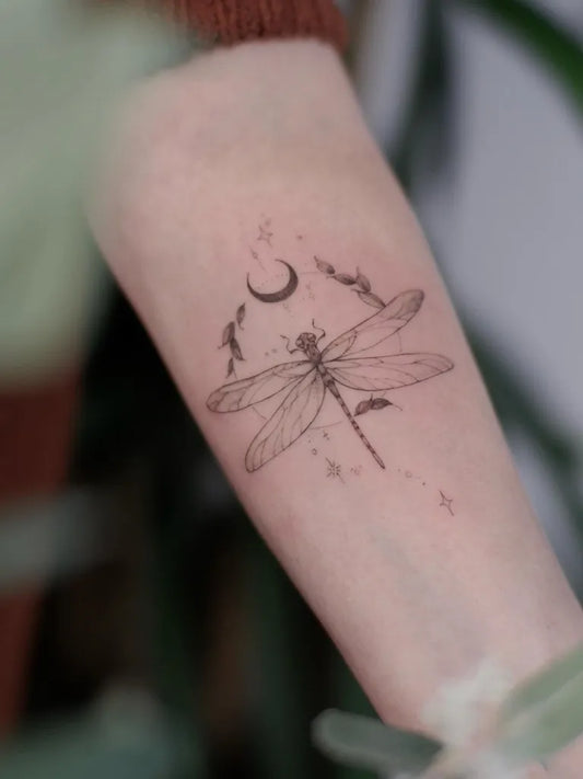 Small Linework Dragonfly Moon and Stars on Women Arm Tattoo by @gracie.tattooer