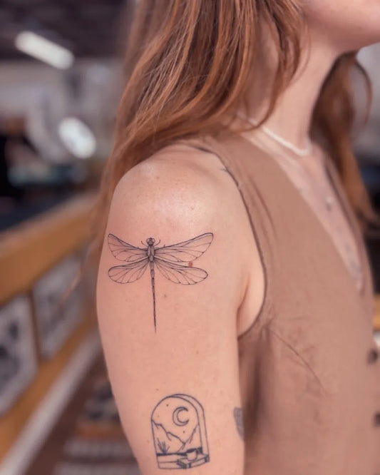 Small Linework Dragonfly and Moon on Women Shoulder Tattoo by @bibi.lea.tattoo