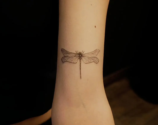 Small Linework Dragonfly on Women Forearm Tattoo by @rudrainktattoo