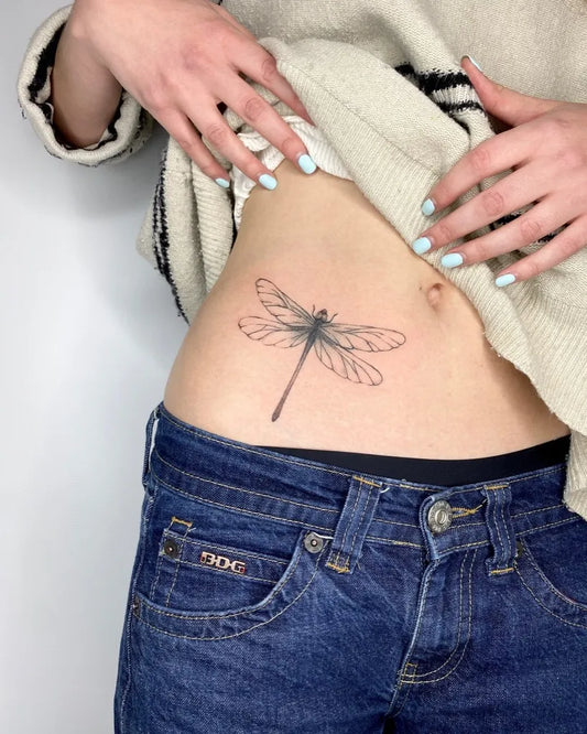 Small Linework Dragonfly on Women Hip Tattoo by @naomirossmasson