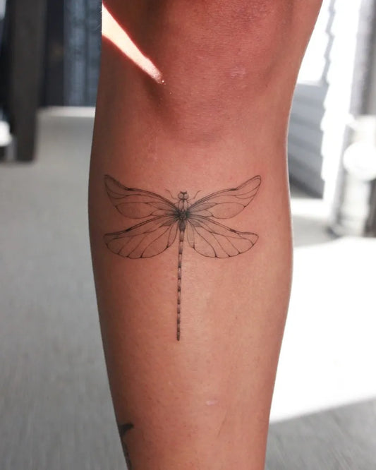Small Linework Dragonfly on Women Thigh Tattoo by @inkedbyv