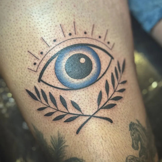 Small Linework Evil Eye with Laurel on Men Leg Tattoo by @misselieshatattoo