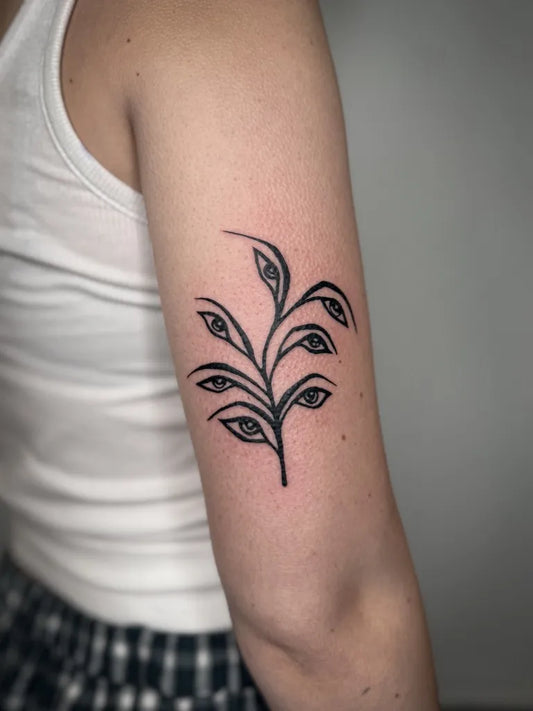 Small Linework Eyed Branch Tattoo on Women Upper Arm by @bekindcassie