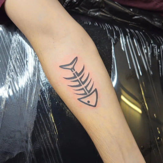 Small Linework Fish Skeleton Tattoo on Men Arm by @tattsbyemilia