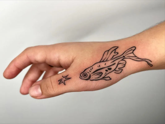 Small Linework Fish and Star Tattoo on Men Wrist by @twofacedserpent