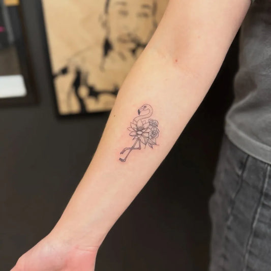 Small Linework Flamingo and Flowers Tattoo on Women Arm by @the.asylum.ink