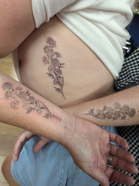 Small Linework Floral Designs on Couple Arms and Torso Matching Tattoo by @vickylou_tattoo82
