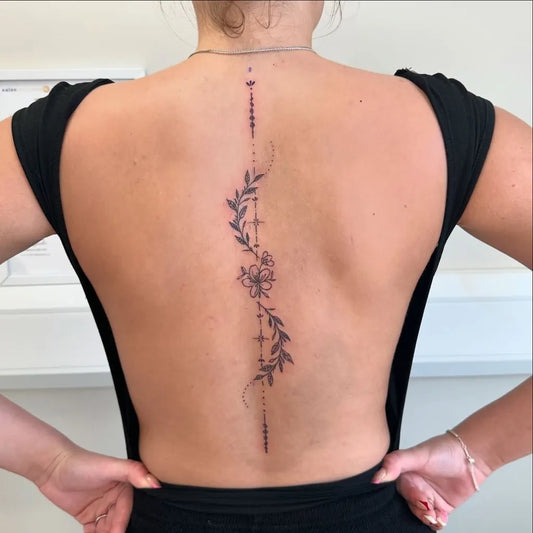 Small Linework Floral on Women Spine Tattoo by @inkedby.kia