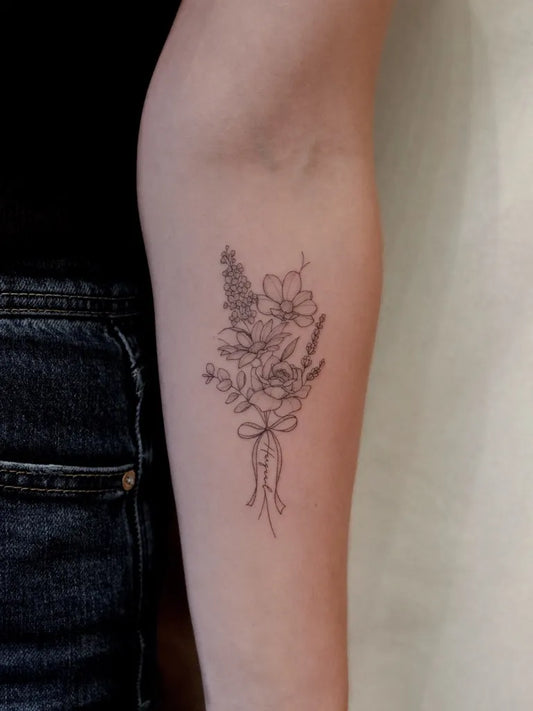 Small Linework Flower Bouquet with Ribbon on Women Arm Flower Tattoo by @tavi_tattoo