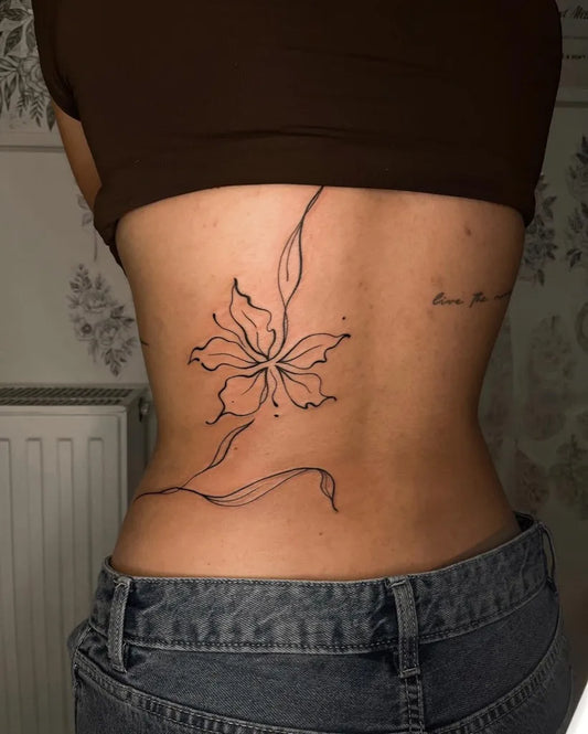 Small Linework Flower and Leaves on Women Back Tattoo by @miriam.freemind