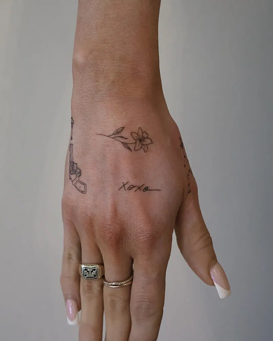 Small Linework Flower and Name on Women Hand Tattoo by @inkhancedbynicole