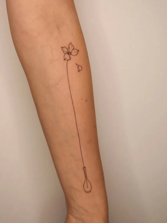 Small Linework Flower with stem and noose on Women Arm Flower Tattoo by @tattoo.esthete