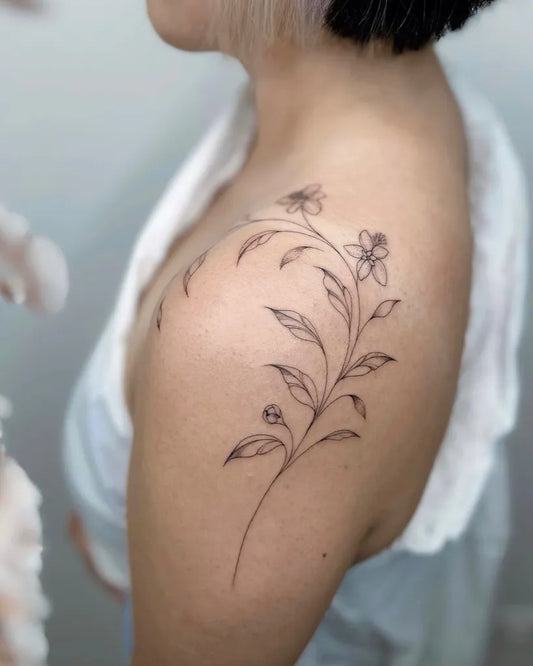 Small Linework Flowers and Branches Tattoo on Women Shoulder by @nothingwildtattoo