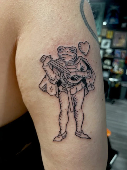 Small Linework Frog Musician Tattoo on Women Arm by @lunathespectre
