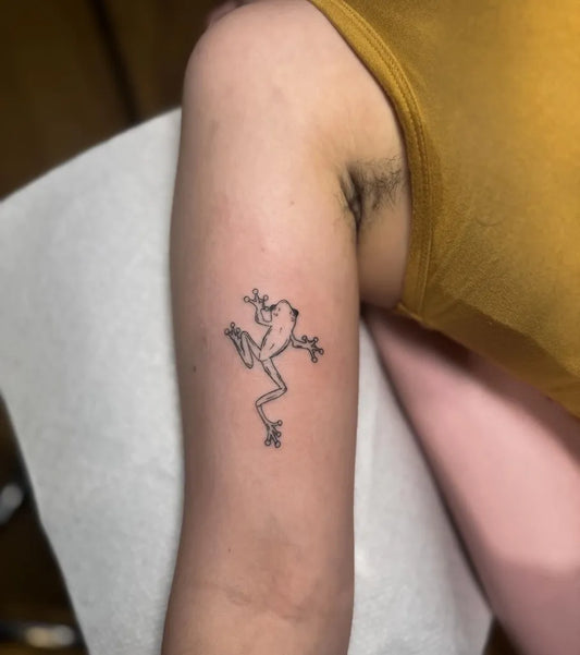 Small Linework Frog Tattoo on Women Arm by @darciebrocktattoo