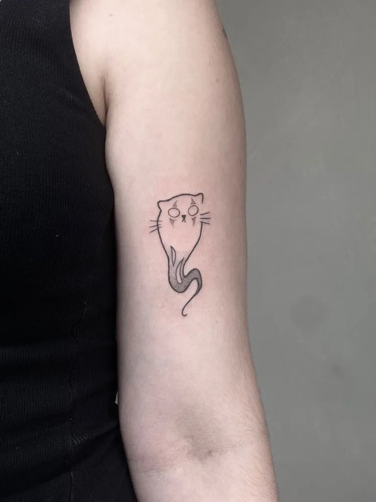 Small Linework Ghost Cat Tattoo on Women Arm by @joandumez