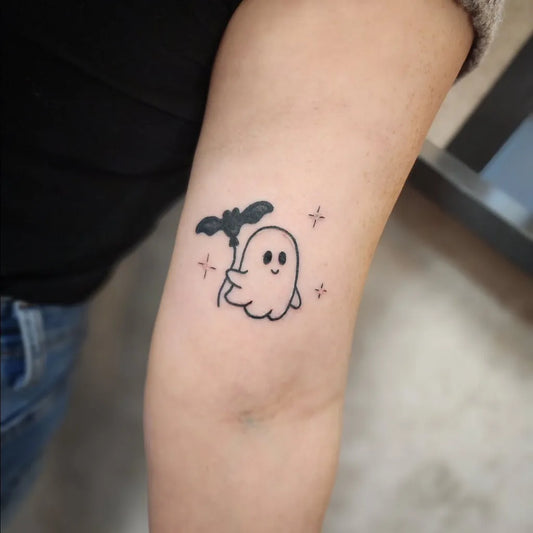 Small Linework Ghost with Bat Tattoo on Women Arm by @nina_distinktiontattoo