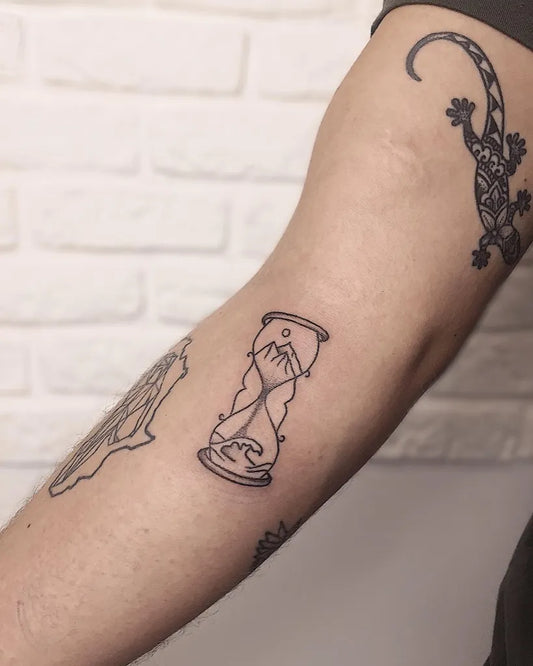 Small Linework Hourglass Mountain Wave Tattoo on Men Arm by @nst.bessarab