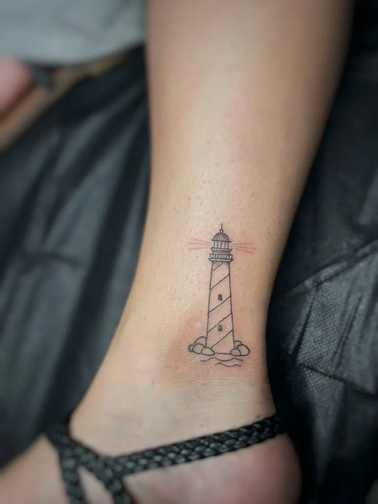 Small Linework Lighthouse Tattoo on Women Ankle by @dedxtattoo