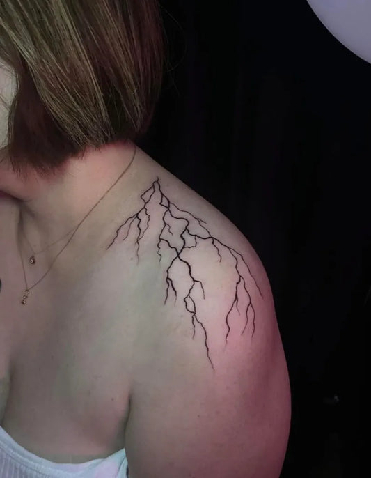 Small Linework Lightning Tattoo on Women Shoulder by @mtztntdr