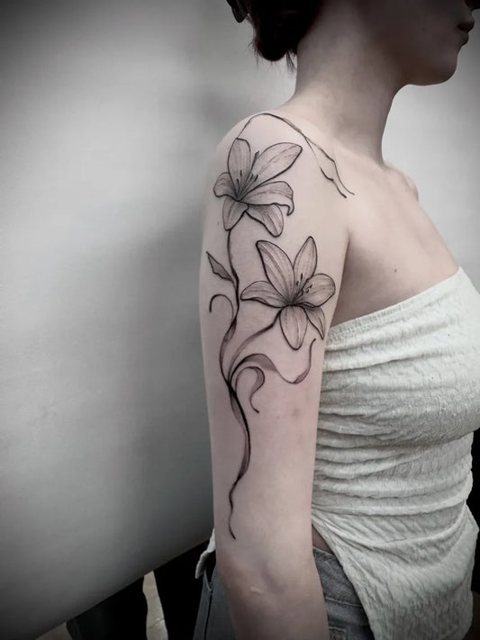 Small Linework Lily Flowers and Vines on Women Shoulder Flower Tattoo by @okeydokeytattooedinburgh