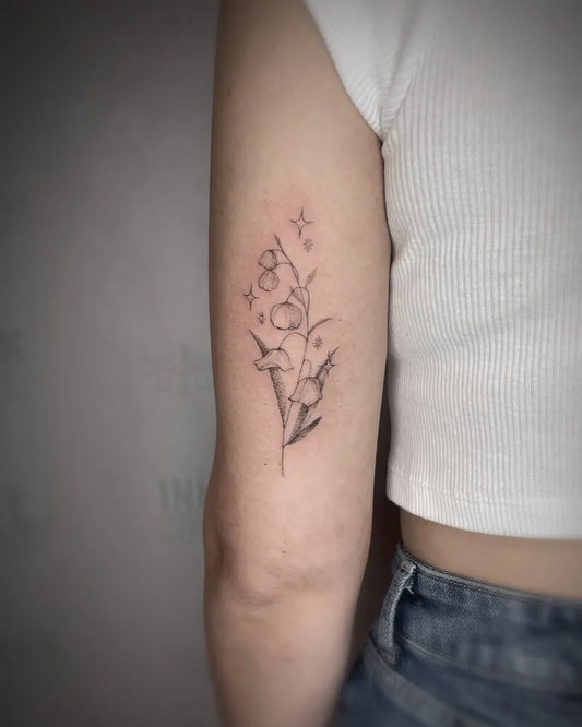 Small Linework Lily of the Valley Flowers and Stars on Women Arm Tattoo by @gagemansfield.tattoos