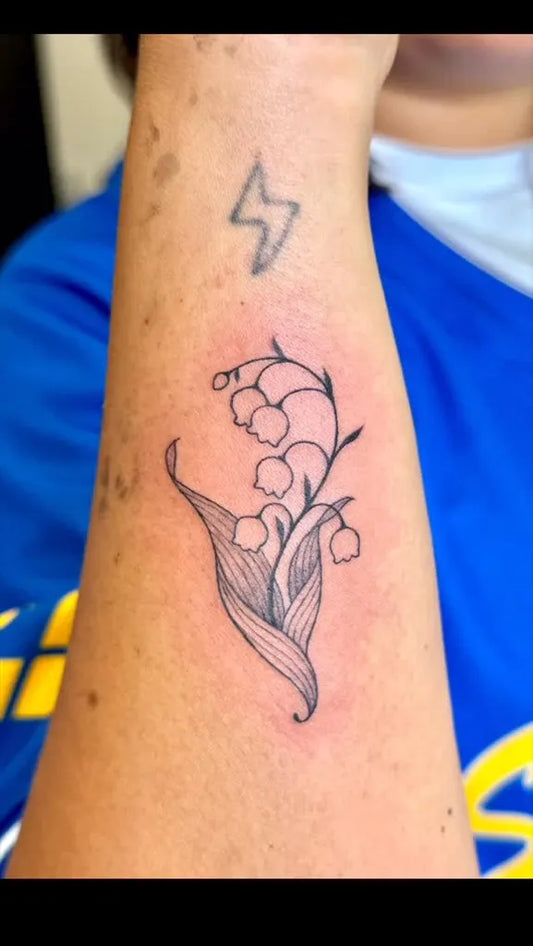 Small Linework Lily of the Valley and Lightning Bolt on Women Arm Tattoo by @medama_dango
