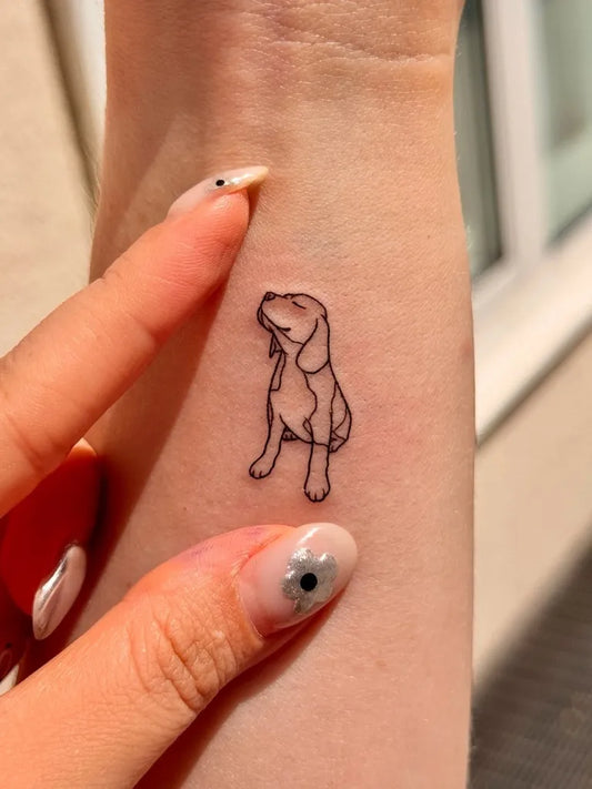 Small Linework Looking Up Puppy on Women Wrist Tattoo by @tinytattooinc