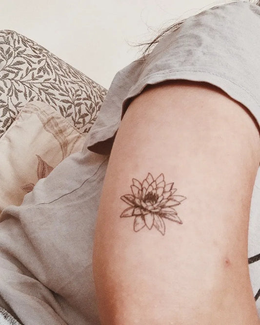 Small Linework Lotus Flower on Women Arm Tattoo by @dailyarttattoo