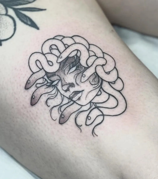 Small Linework Medusa on Women Thigh Tattoo by @ladypiratestattoo