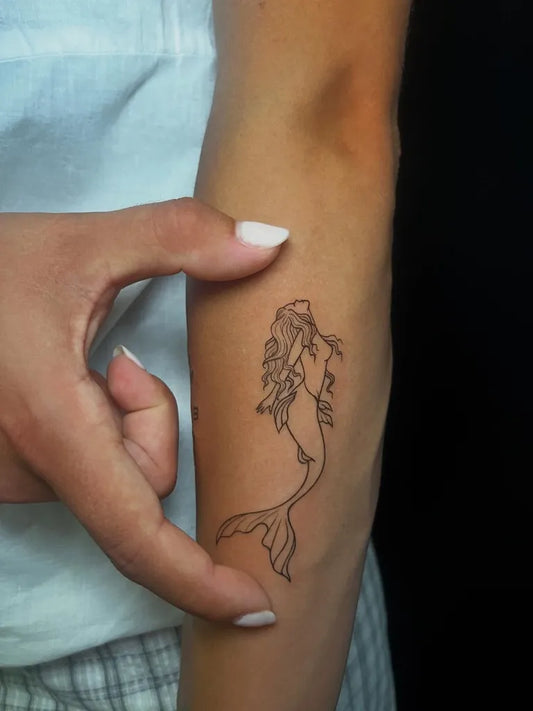 Small Linework Mermaid Tattoo on Women Forearm by @siwi.ink