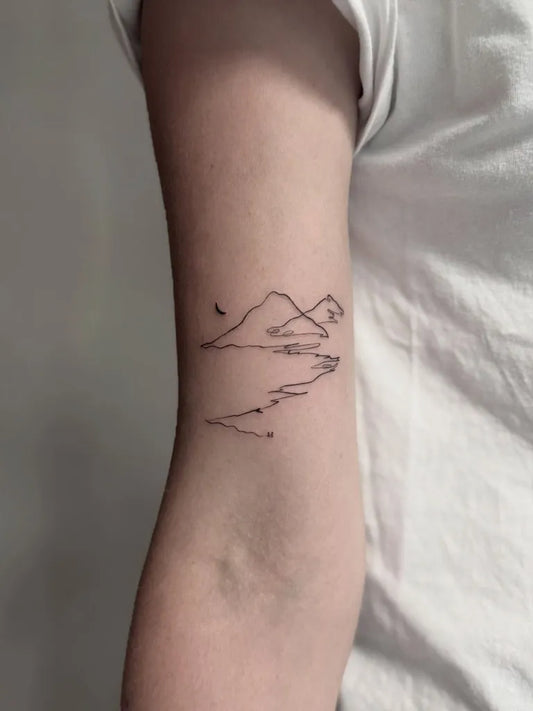 Small Linework Mountain and Lake Tattoo on Women Arm by @piece_of_art_tattoo