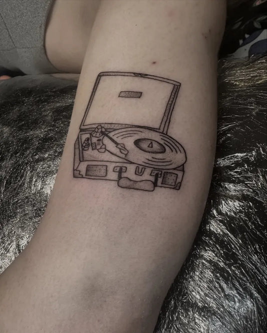 Small Linework Open Record Player Music Tattoo on Women Arm by @antclaytattoo