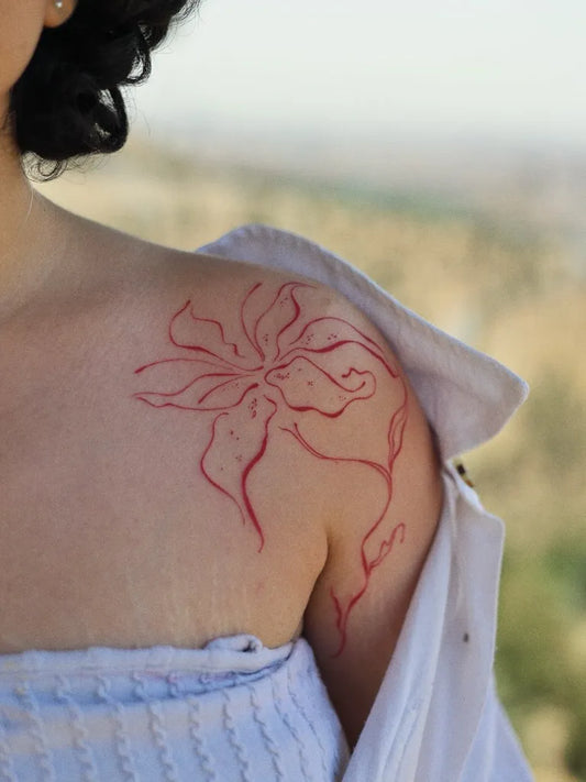 Small Linework Orchid on Women Shoulder Flower Tattoo by @bali.tattoo_