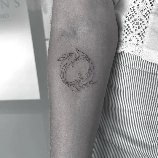 Small Linework Pisces Tattoo on Women Arm by @6moonstattoostudio