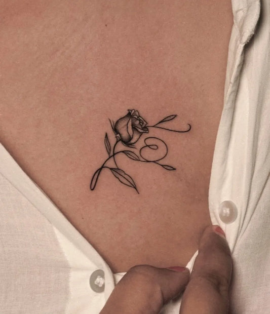 Small Linework Rose with Leaves on Women Collarbone Tattoo by @ocean_arts__