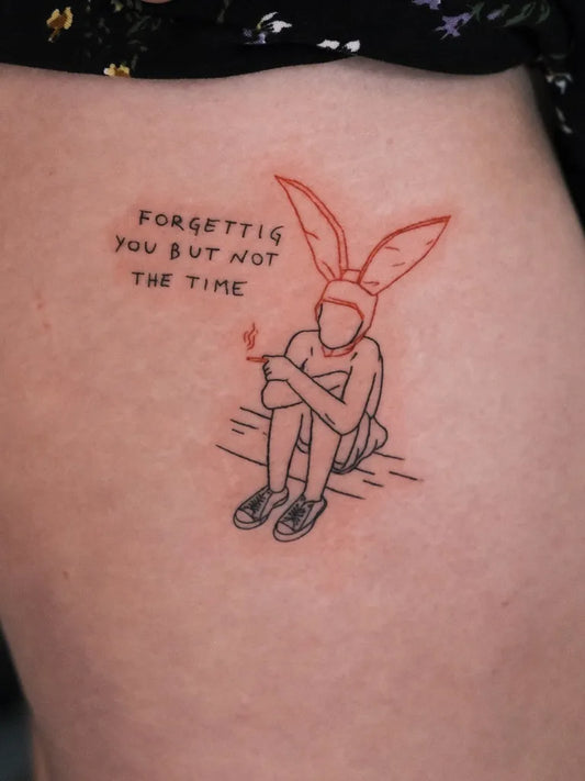 Small Linework Sitting Figure with Bunny Ears and Cigarette Forget Me Not Quote Tattoo on Women Hip by @studio4.no