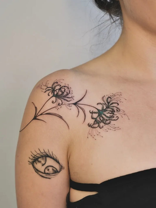 Small Linework Spider Lily Eye Tattoo on Women Shoulder by @seas.tattoo