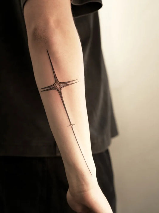 Small Linework Star Cross Tattoo on Men Arm by @flashlightuniverse