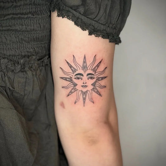 Small Linework Sun with Face on Women Arm Tattoo by @inkspatattoo